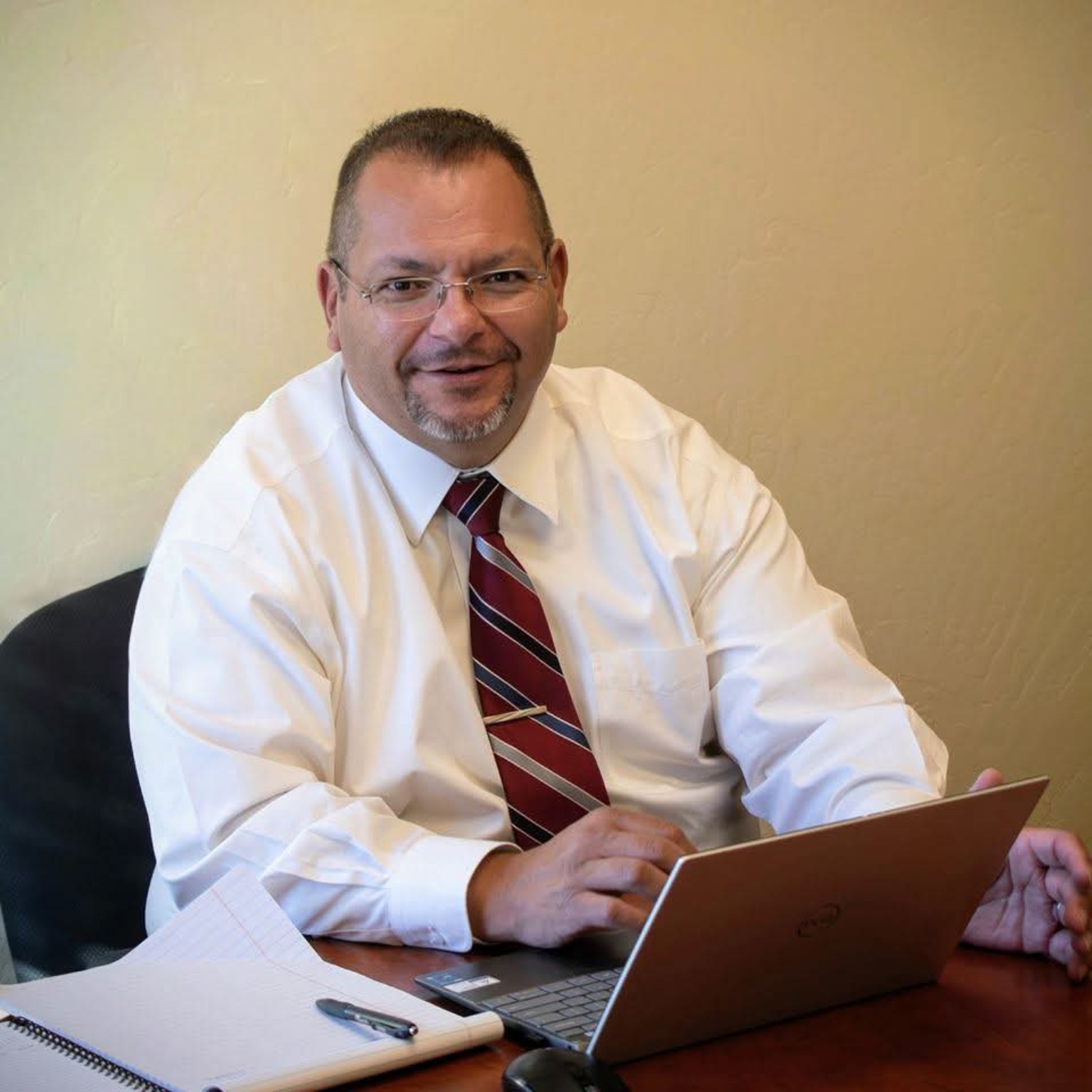 Devan Salazar, MAcc, seated at his desk with a laptop